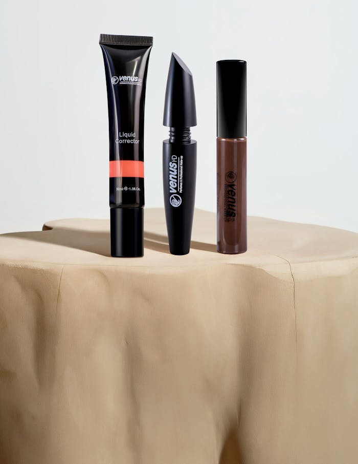 Elegant beauty products elegantly displayed on a natural stone surface under soft lighting.